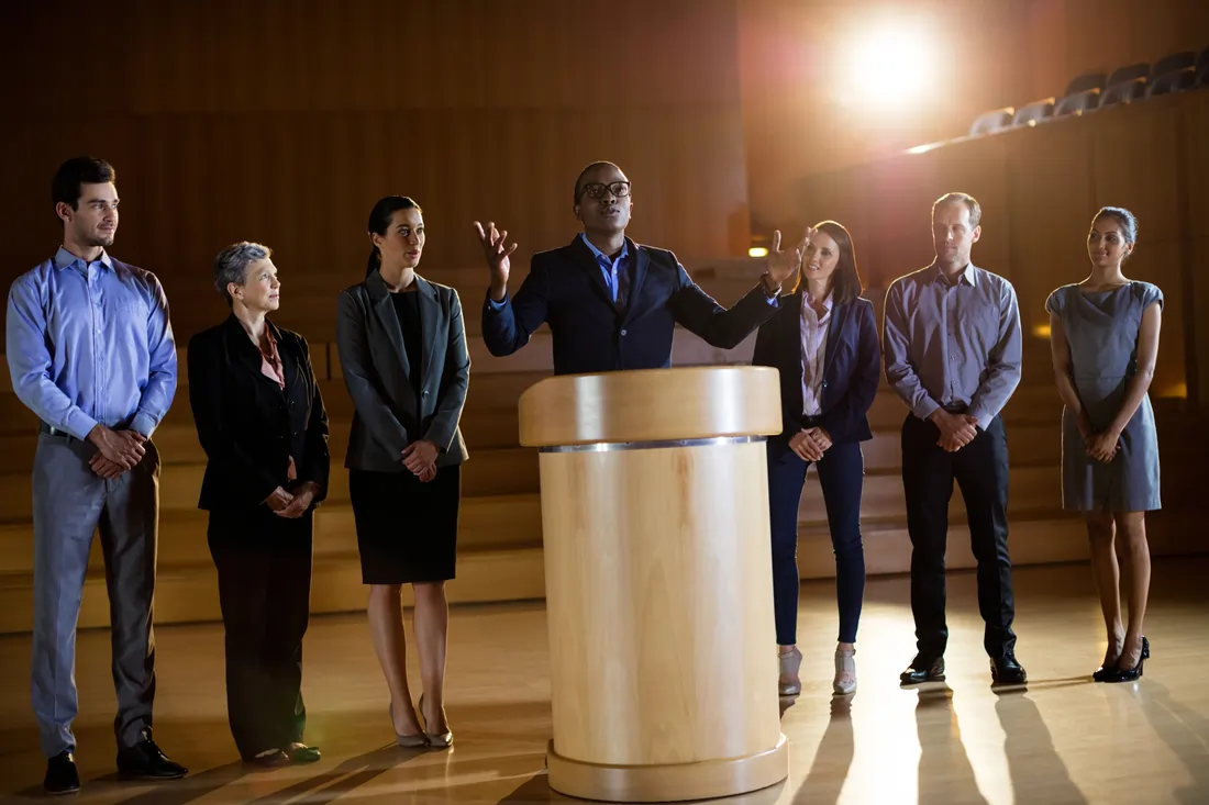 Speaker at podium presenting award ceremony